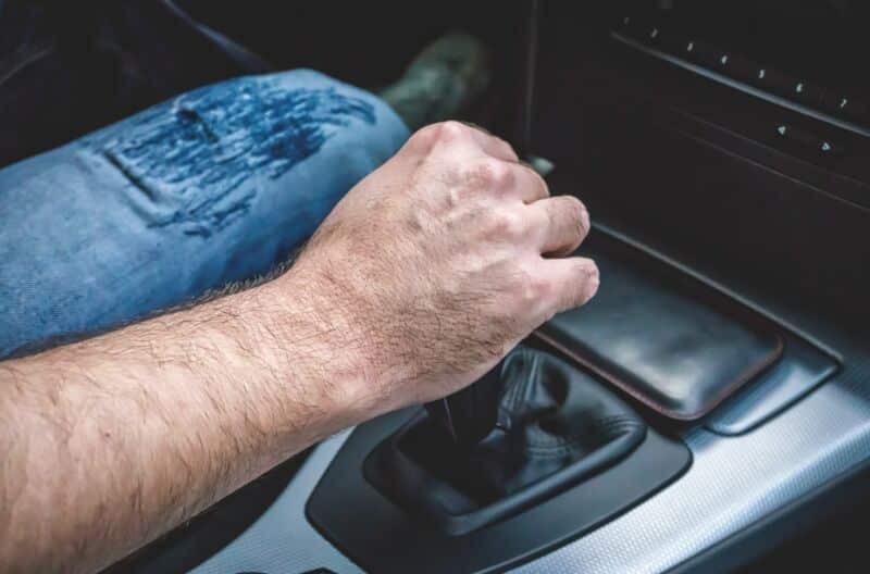 La main d un homme tient un changement de vitesse dans une BMW d'occasion