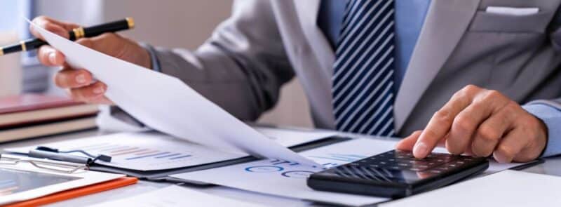 Business Financing, businessman doing finances and calculating about the cost to real estate investm