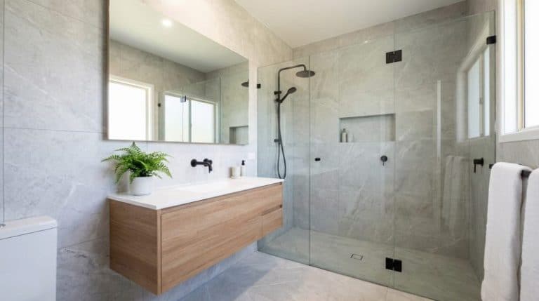 Sleek modern bathroom with marble tiles and wood vanity